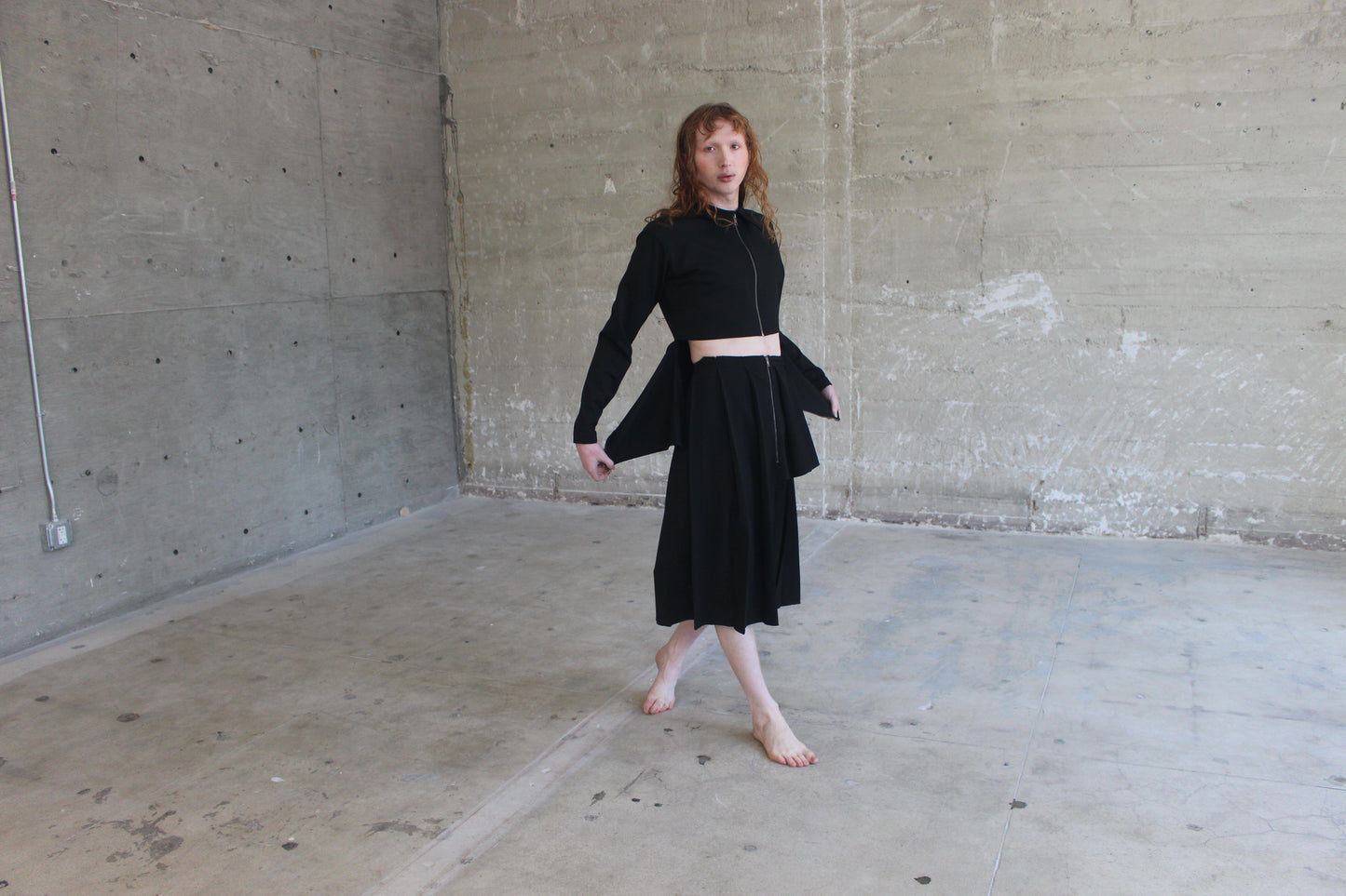 black jacket and pleated skirt
