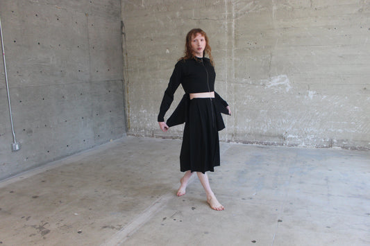 black jacket and pleated skirt